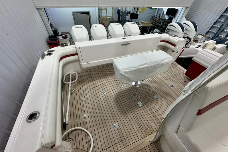 Slide: The Image of 2020 Intrepid 475 Sport Yacht interior with teak flooring and multiple outboard engines. - 19