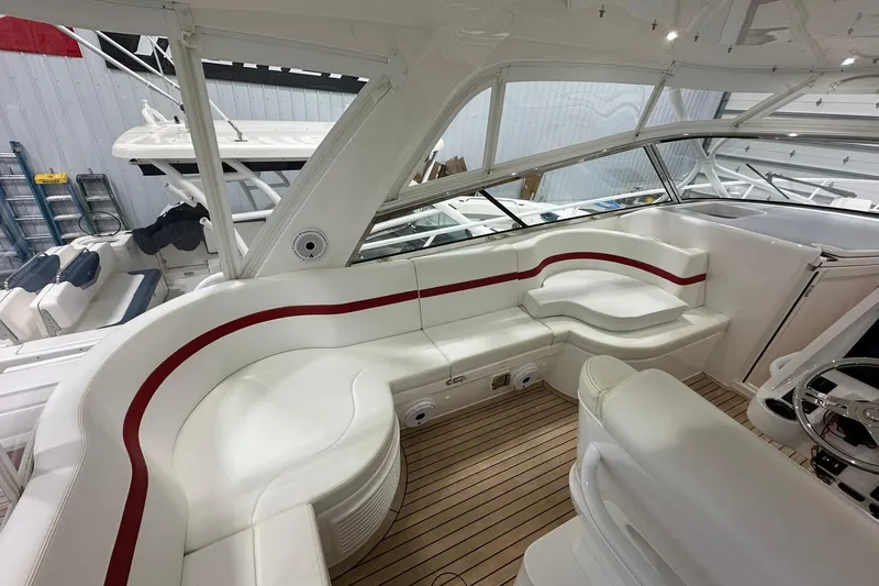 Slide: The Image of Interior of 2020 Intrepid 475 Sport Yacht with white seating and red accents. - 2