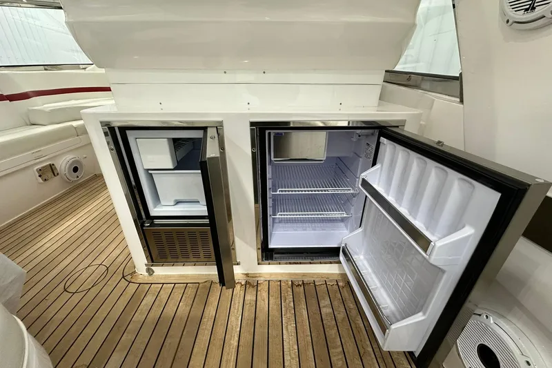 Slide: The Image of Open refrigerators on 2020 Intrepid 475 Sport Yacht, showcasing spacious interior and sleek design. - 21