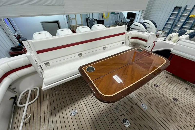 Slide: The Image of 2020 Intrepid 475 Sport Yacht interior with wooden table and white seating. - 22