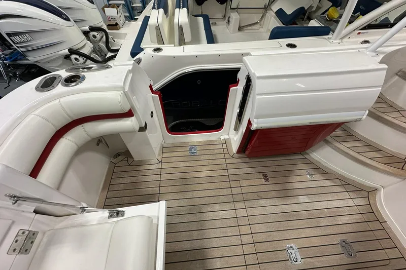 Slide: The Image of 2020 Intrepid 475 Sport Yacht interior with teak flooring and white seating. - 23
