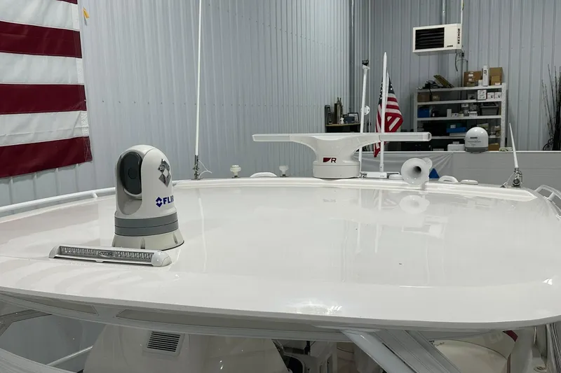 Slide: The Image of 2020 Intrepid 475 Sport Yacht roof with radar and FLIR camera in a garage setting. - 24
