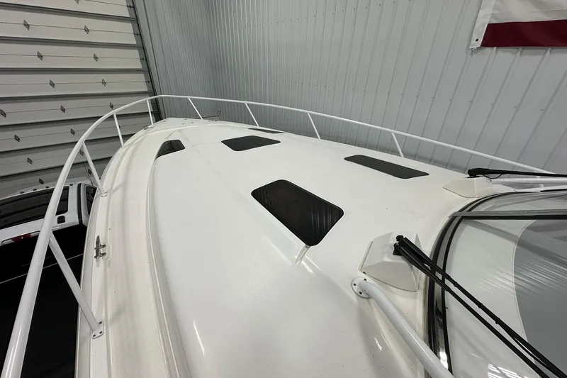 Slide: The Image of 2020 Intrepid 475 Sport Yacht deck view in a storage facility. - 25