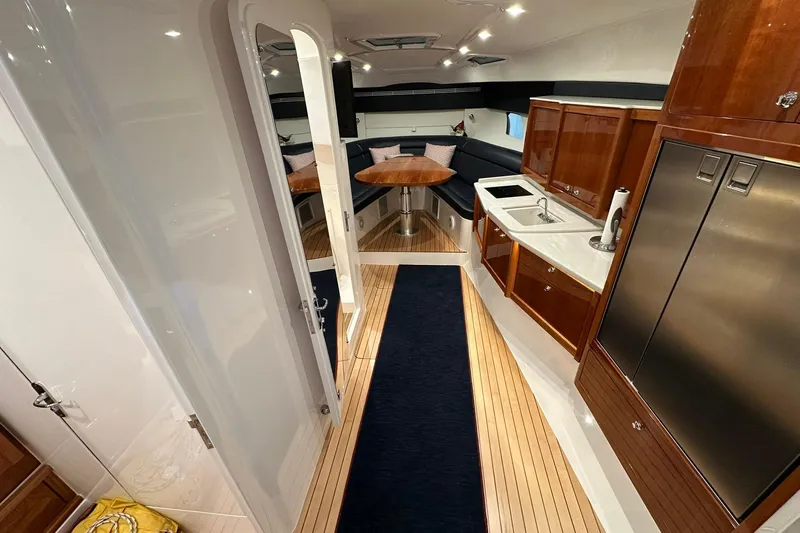 Slide: The Image of Luxurious interior of 2020 Intrepid 475 Sport Yacht with modern kitchen and seating area. - 3