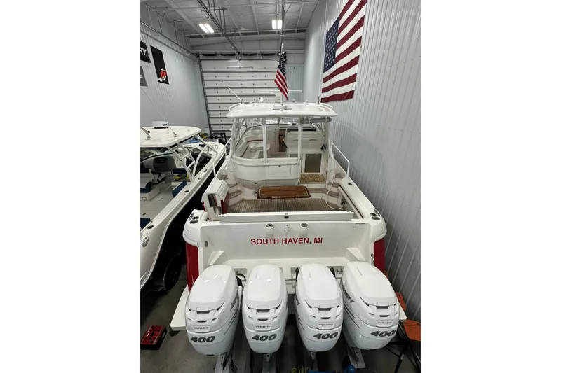 Slide: The Image of 2020 Intrepid 475 Sport Yacht in a garage, featuring quad 400 engines, South Haven, MI. - 33