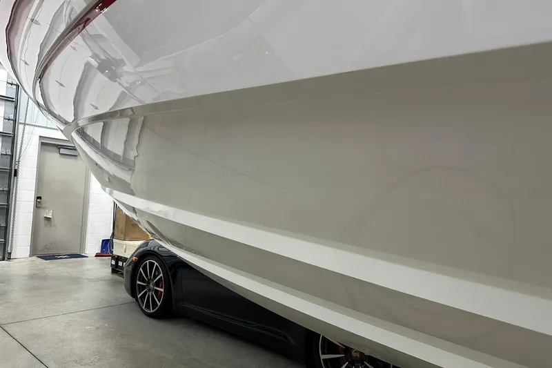 Slide: The Image of 2020 Intrepid 475 Sport Yacht in garage, partially covering a sports car. - 37