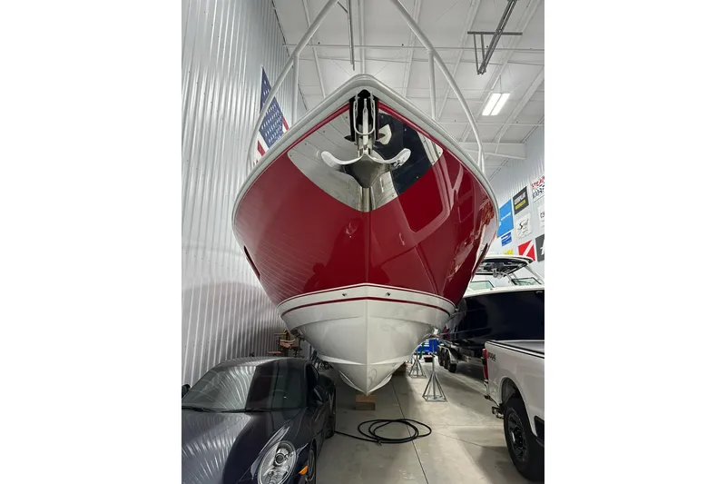 Slide: The Image of 2020 Intrepid 475 Sport Yacht with red hull in indoor storage facility. - 38