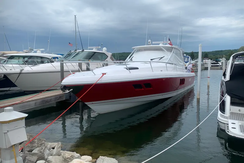 Slide: The Image of 2020 Intrepid 475 Sport Yacht docked at marina, featuring sleek red and white design. - 40
