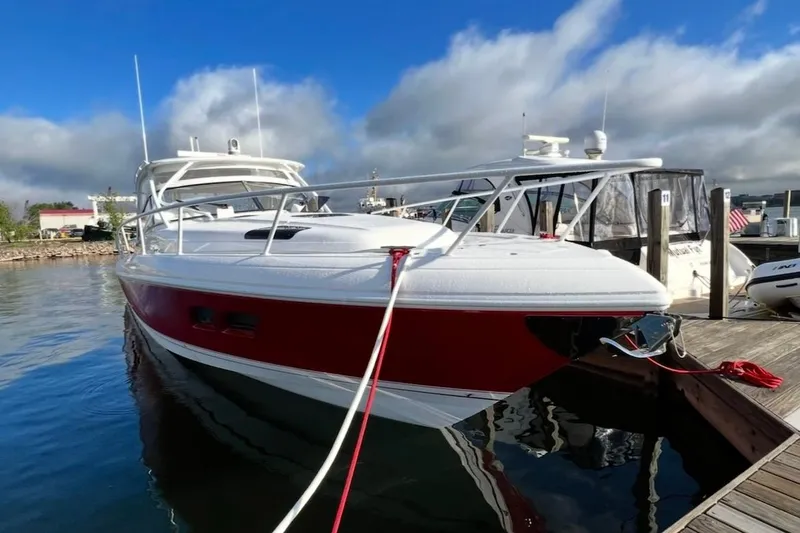 Slide: The Image of 2020 Intrepid 475 Sport Yacht docked, featuring sleek red and white design under a blue sky. - 41