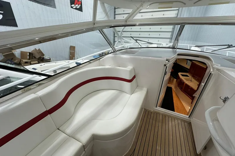 Slide: The Image of Interior view of 2020 Intrepid 475 Sport Yacht with white seating and cabin entrance. - 6