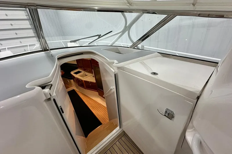 Slide: The Image of Interior view of 2020 Intrepid 475 Sport Yacht, showcasing sleek cabin entrance and modern design. - 7