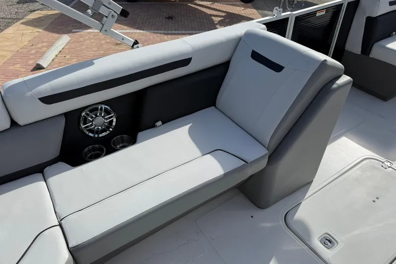 Slide: The Image of 2024 Hurricane FunDeck 2260 RE OB boat interior with gray seating and cup holders. - 10