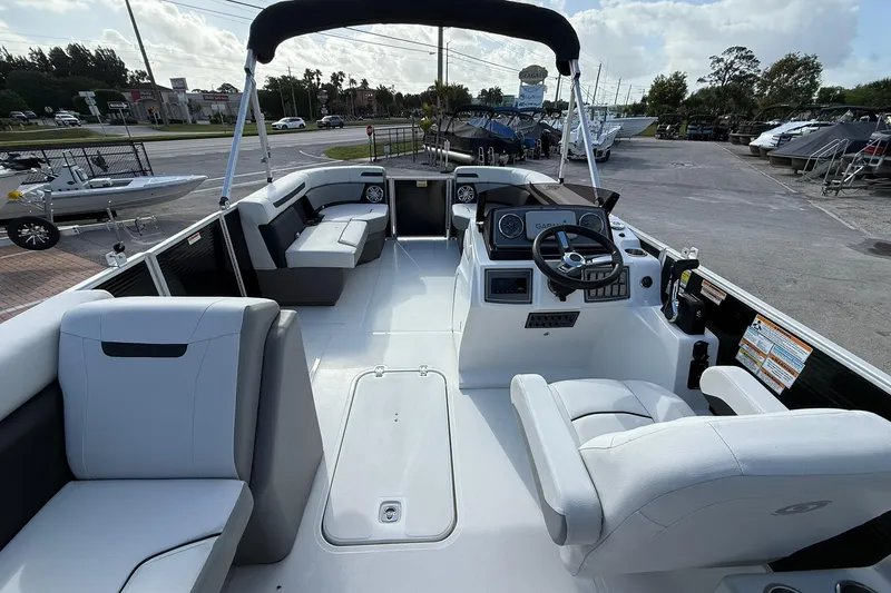 Slide: The Image of 2024 Hurricane FunDeck 2260 RE OB boat interior with seating and steering console. - 11