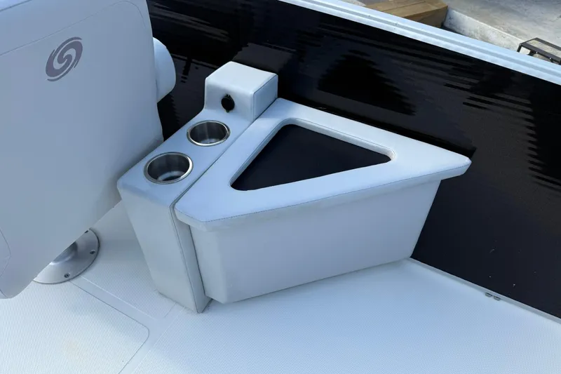 Slide: The Image of 2024 Hurricane FunDeck 2260 RE OB boat interior with cup holders and storage compartment. - 12