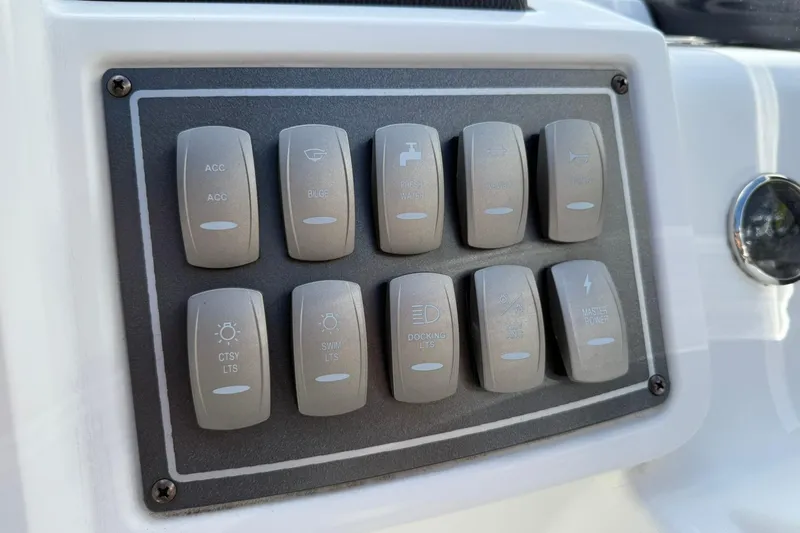 Slide: The Image of Control panel of 2024 Hurricane FunDeck 2260 RE OB boat with labeled switches. - 17