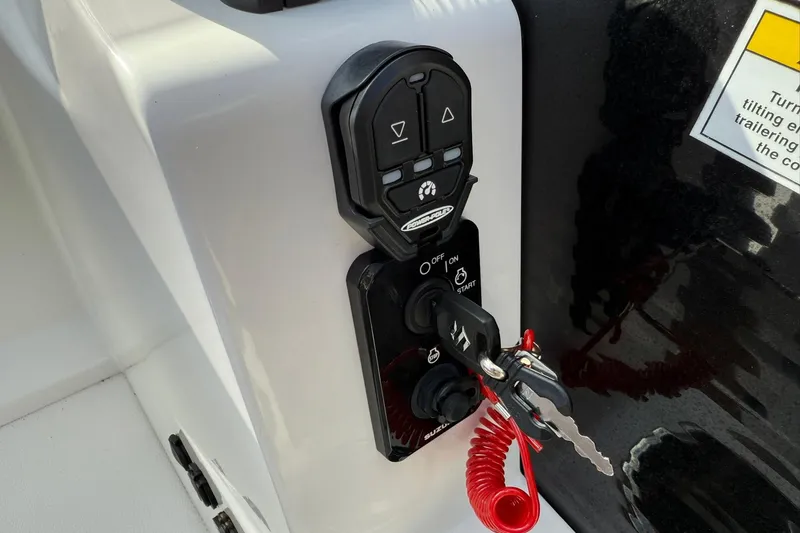 Slide: The Image of Control panel of 2024 Hurricane FunDeck 2260 RE OB boat with ignition key and safety lanyard. - 18