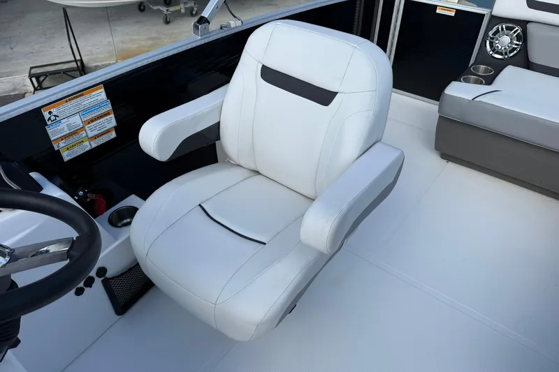 Slide: The Image of 2024 Hurricane FunDeck 2260 RE OB boat interior with white captain's chair and console. - 21
