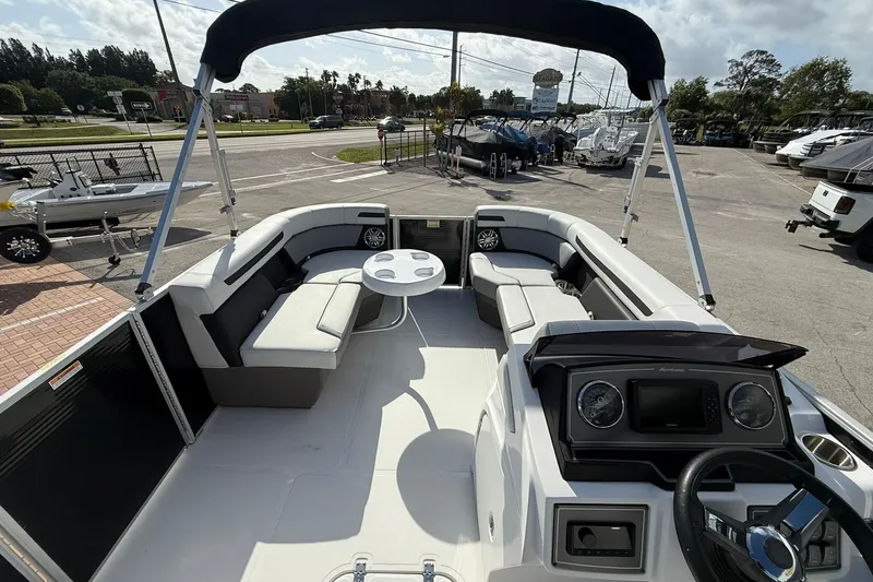 Slide: The Image of 2024 Hurricane FunDeck 2260 RE OB boat interior with seating and helm. - 23