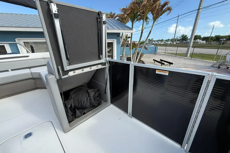 Slide: The Image of 2024 Hurricane FunDeck 2260 RE OB boat interior with storage compartment open. - 29