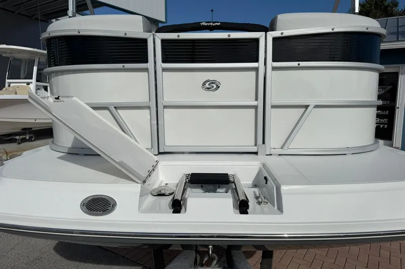 Slide: The Image of 2024 Hurricane FunDeck 2260 RE OB boat with open hatch and ladder on deck. - 4