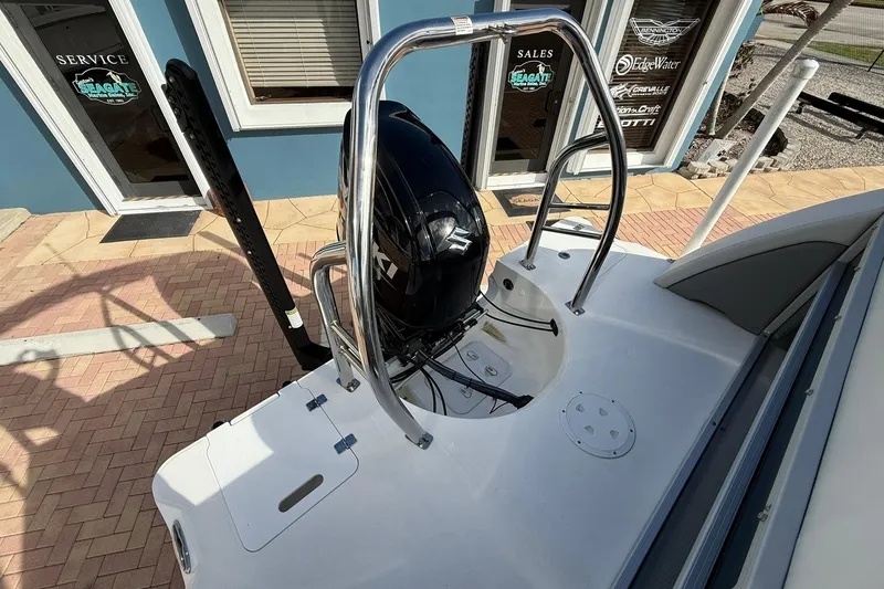 Slide: The Image of 2024 Hurricane FunDeck 2260 RE OB boat with Suzuki outboard motor, docked near service area. - 5