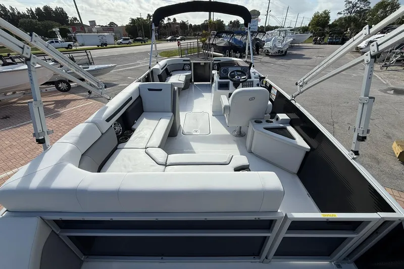 Slide: The Image of 2024 Hurricane FunDeck 2260 RE OB boat interior with spacious seating and modern helm. - 7