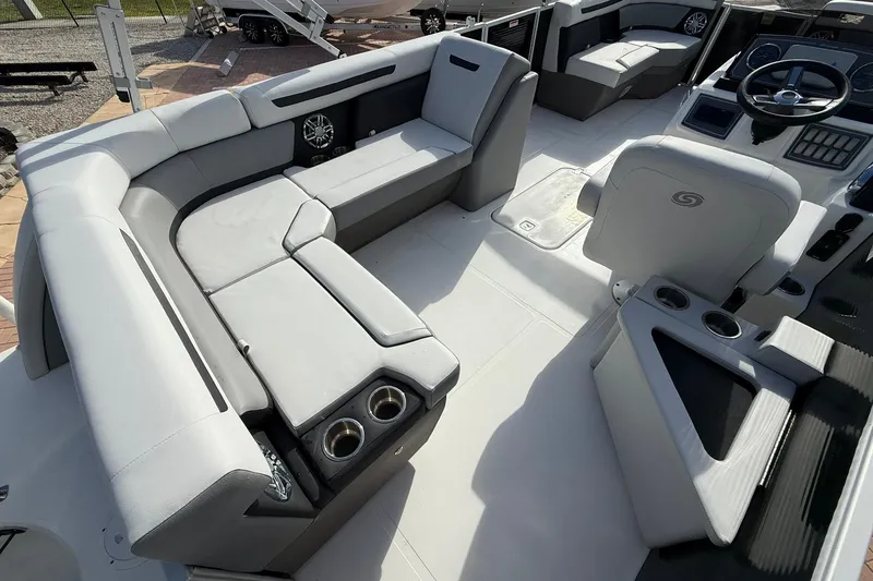 Slide: The Image of 2024 Hurricane FunDeck 2260 RE OB boat interior with spacious seating and modern helm. - 8