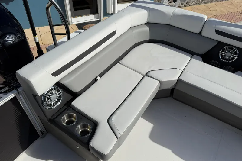 Slide: The Image of 2024 Hurricane FunDeck 2260 RE OB boat interior with gray seating and cup holders. - 9