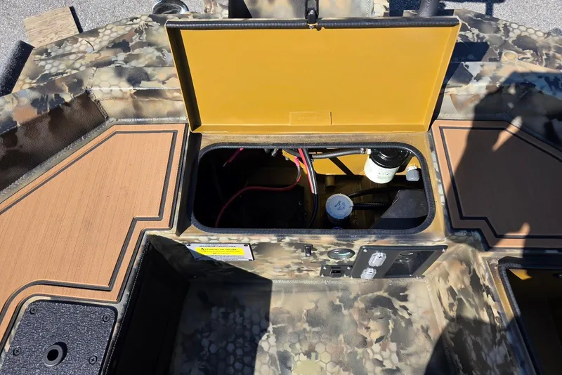 Slide: The Image of Open storage compartment in Excel 1854 F4 boat, 2026 model, with camouflage design. - 20