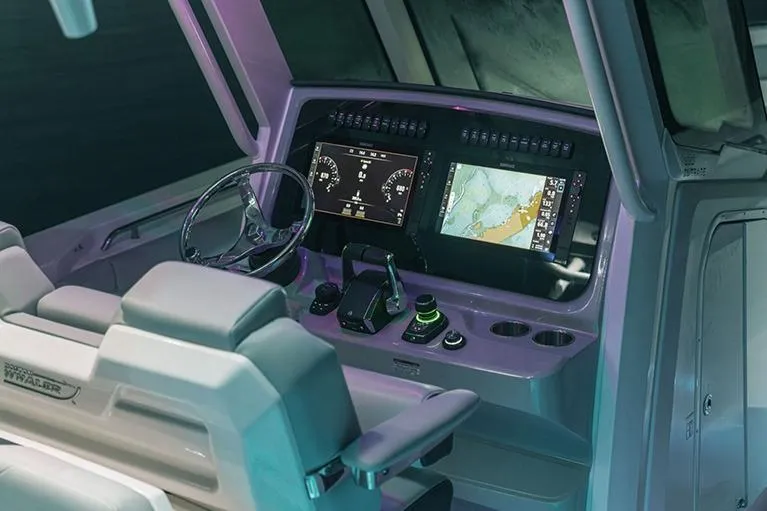 Slide: The Image of Manufacturer Provided Image: 2026 Boston Whaler 330 Outrage helm with advanced navigation displays and controls. - 4