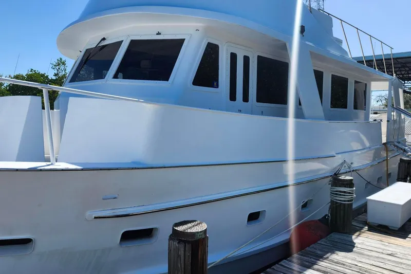 The Image of 1979 Marine Trader 50 Trawler docked, showcasing classic design and spacious deck. - 0
