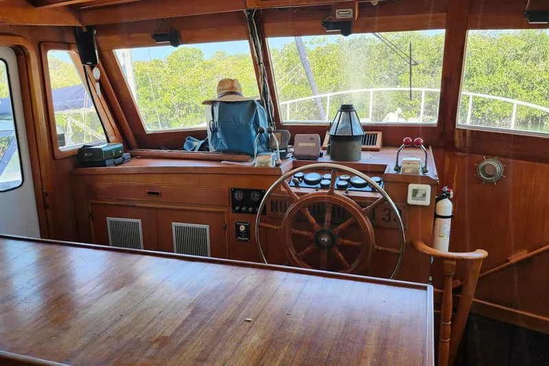 Slide: The Image of 1979 Marine Trader 50 Trawler helm with wooden wheel and navigation equipment. - 11