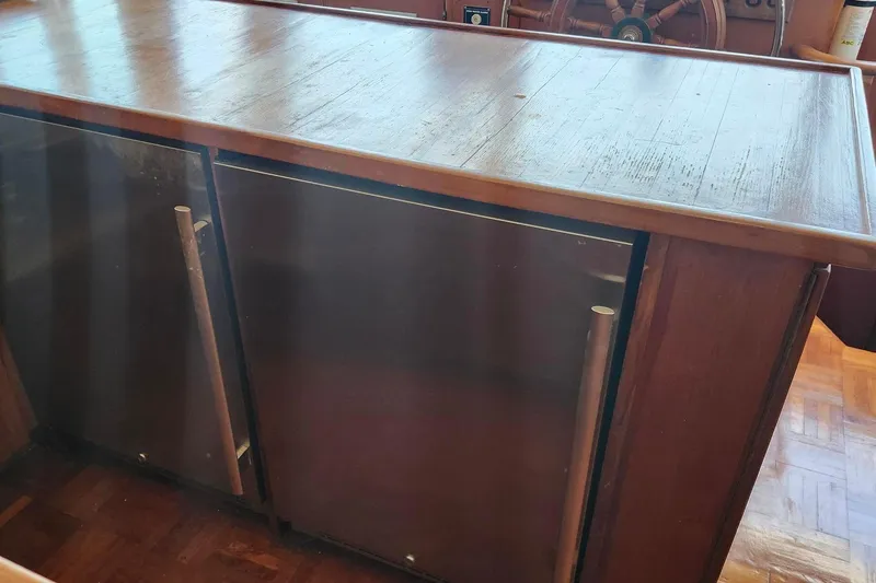 Slide: The Image of Wooden interior of 1979 Marine Trader 50 Trawler with built-in cabinets and steering wheel. - 12