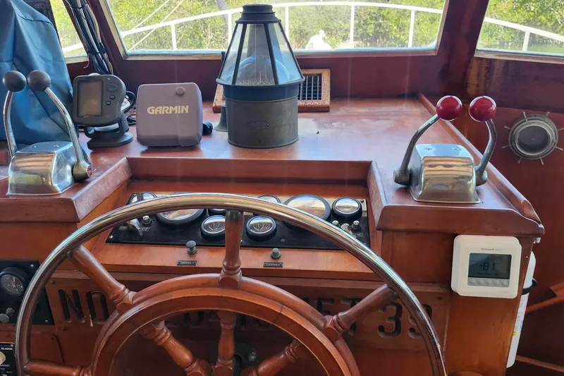 Slide: The Image of Helm of 1979 Marine Trader 50 Trawler with navigation instruments and wooden steering wheel. - 14