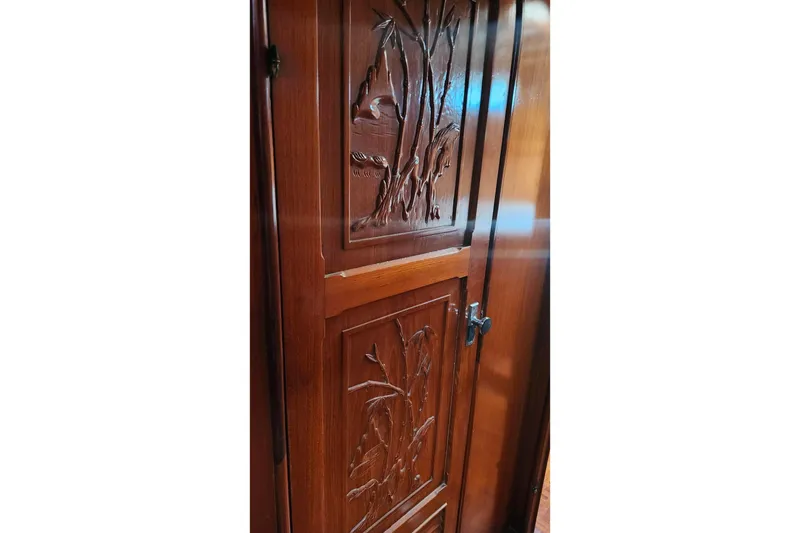 Slide: The Image of Intricately carved wooden door on a 1979 Marine Trader 50 Trawler yacht. - 17