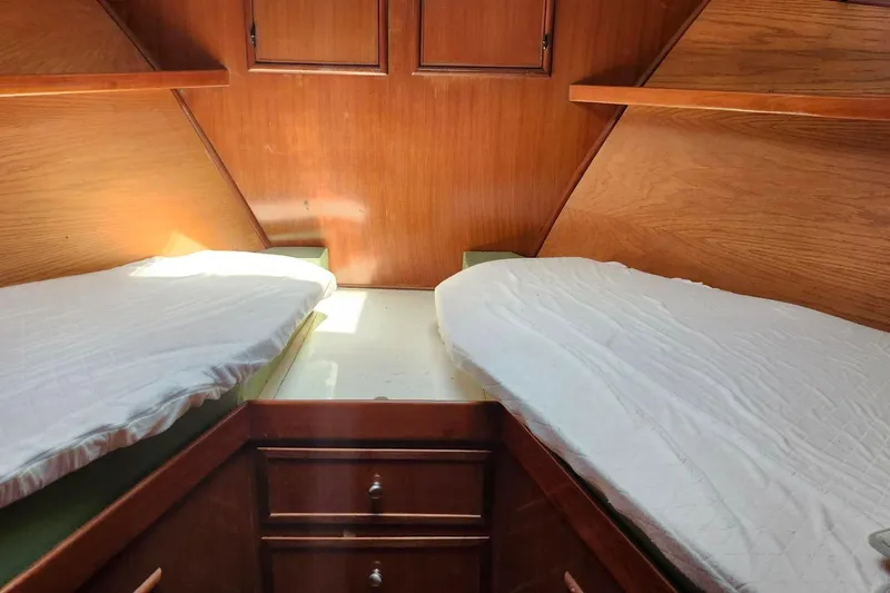 Slide: The Image of Interior cabin of 1979 Marine Trader 50 Trawler with twin beds and wooden cabinetry. - 18