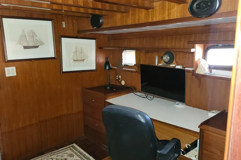 Slide: The Image of Interior of 1979 Marine Trader 50 Trawler with wooden desk and nautical decor. - 20