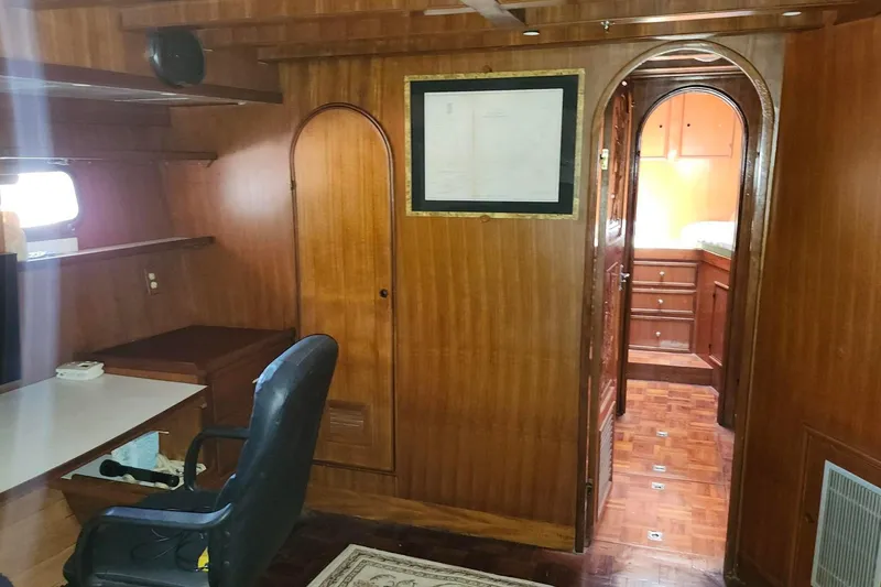 Slide: The Image of Interior of 1979 Marine Trader 50 Trawler with wooden paneling and office space. - 21
