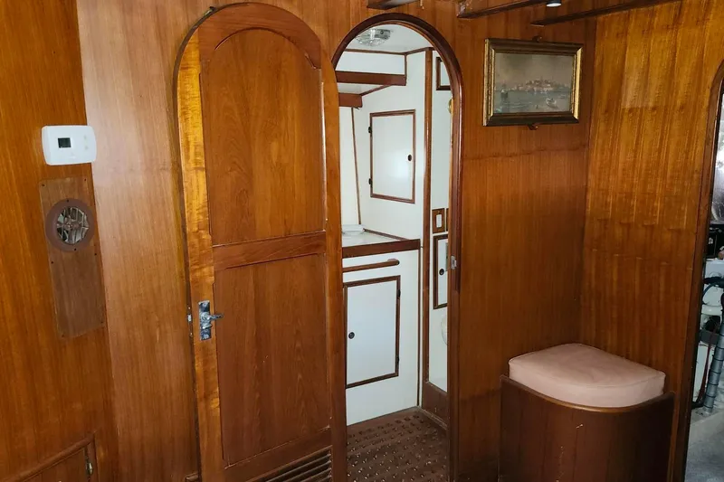 Slide: The Image of Interior of 1979 Marine Trader 50 Trawler with wooden paneling and nautical decor. - 22