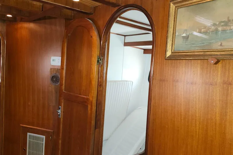 Slide: The Image of Interior of 1979 Marine Trader 50 Trawler with wooden paneling and nautical artwork. - 24