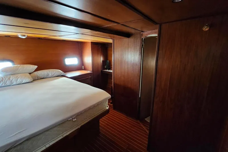 Slide: The Image of Cozy bedroom in 1979 Marine Trader 50 Trawler with wooden interior and natural light. - 26