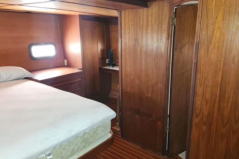 Slide: The Image of 1979 Marine Trader 50 Trawler cabin interior with wood paneling and bed. - 27
