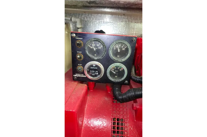 Slide: The Image of Control panel of a 1979 Marine Trader 50 Trawler with gauges and switches. - 33