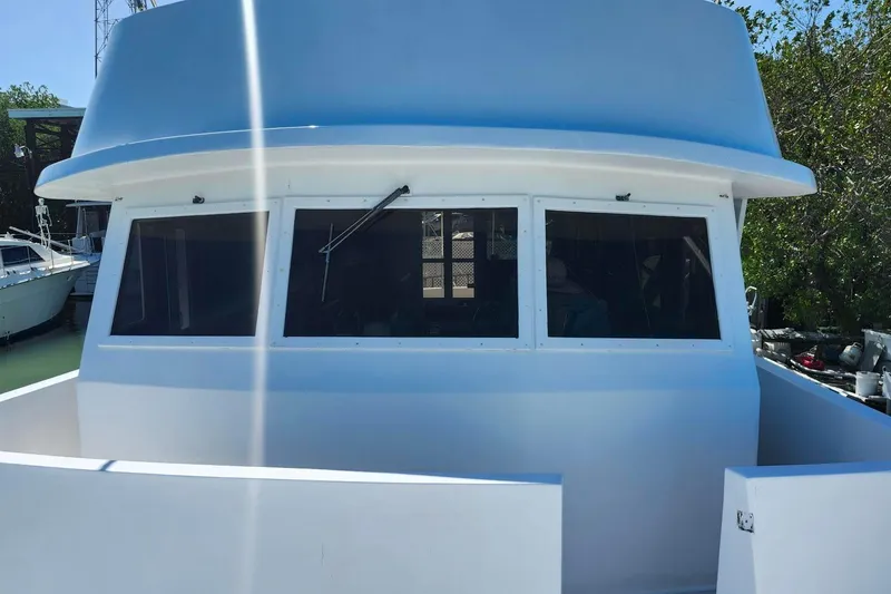 Slide: The Image of 1979 Marine Trader 50 Trawler, front view with windows and white exterior. - 7