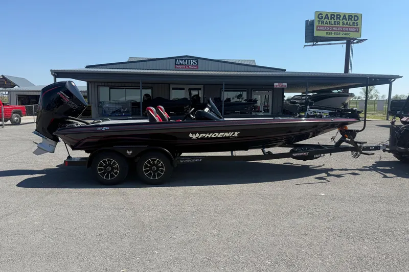 Slide: The Image of 2026 Phoenix 721 ZXL boat on trailer outside dealership, featuring sleek design and powerful engine. - 3