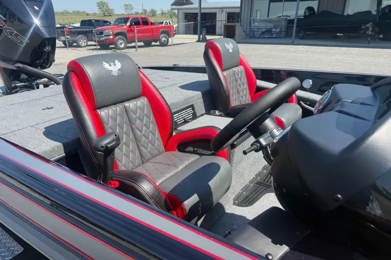 Slide: The Image of 2026 Phoenix 721 ZXL boat interior with red and gray seats, steering wheel, and dashboard. - 6