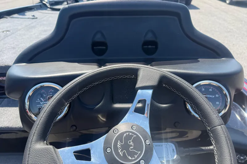 Slide: The Image of 2026 Phoenix 721 ZXL dashboard with steering wheel and gauges in a boat cockpit. - 8