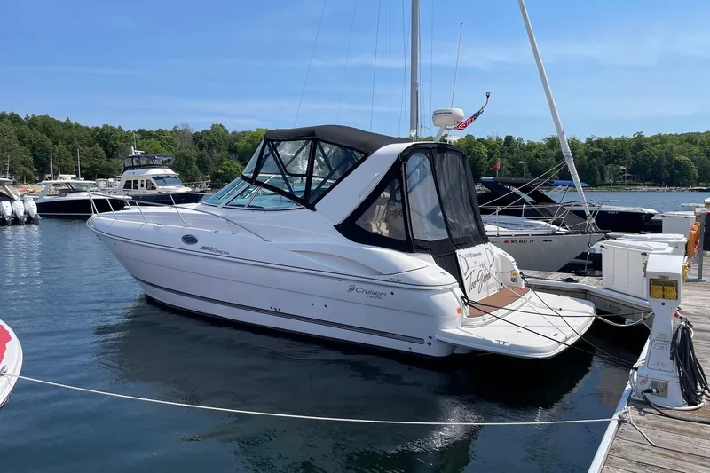 Slide: The Image of 2005 Cruisers Yachts 320 Express docked at marina, clear sky, calm water. - 2
