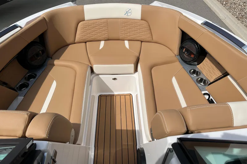 Slide: The Image of Luxurious interior of 2025 MasterCraft X24 boat with tan seating and wood flooring. - 10