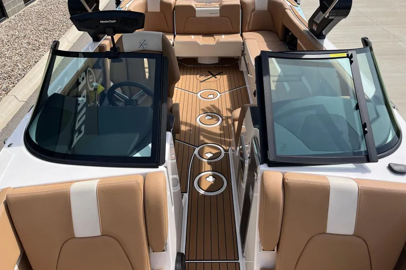 Slide: The Image of 2025 MasterCraft X24 boat interior with tan seating and sleek design. - 11